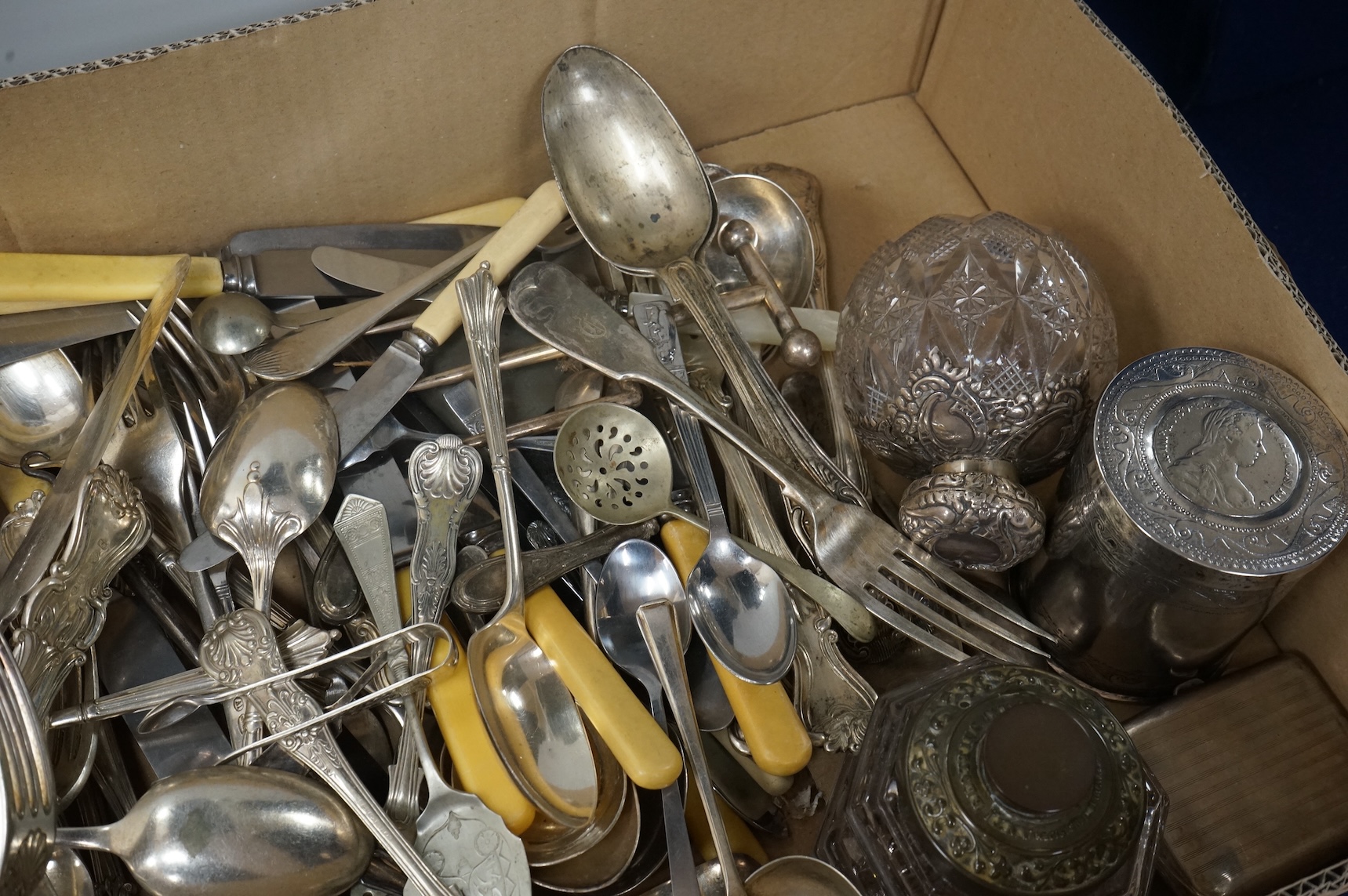 A pair of Victorian silver King's pattern table spoons by George Adams, London, 1858, a silver teaspoon, a mounted glass scent bottle, a silver cigarette case, a continental canister with inset coin lid, and assorted pla